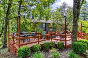 a wooden deck with tables and chairs and trees at Pool- Pinecrest Townhomes-1King-2Queen Unit-Updated in Pigeon Forge