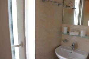 a bathroom with a sink and a mirror at Hotel Barca D'Oro in Bellaria-Igea Marina