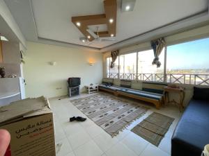 a living room with a couch and a large window at شقه بالغردقه in Hurghada