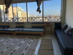 a living room with a couch and a large window at شقه بالغردقه in Hurghada