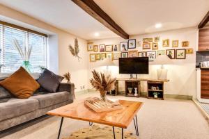 a living room with a couch and a coffee table at The Loft @ The Old George Inn in South Cerney