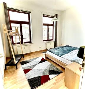 a bedroom with a bed and a rug on the floor at City Central Hegelstraße in Magdeburg