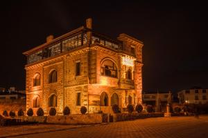 a large brick building with lights on it at night at Lunas Cappadocia in Nevsehir