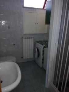 a bathroom with a sink and a washing machine at Casa Lulù in Santa Maria La Carità