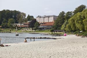 a group of people on a beach near the water at Hotel Christiansminde in Svendborg