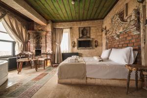 a bedroom with a bed and a brick wall at Lunas Cappadocia in Nevşehir