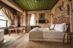 a bedroom with a bed and a brick wall at Lunas Cappadocia in Nevsehir