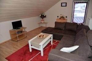 a living room with a couch and a coffee table at Haus Rosenbühl in Warmensteinach