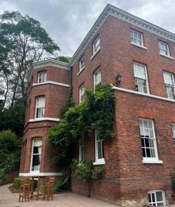 a red brick building with a table in front of it at Kateshill House Bed & Breakfast in Bewdley