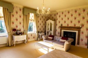 a living room with a couch and a fireplace at Kateshill House Bed & Breakfast in Bewdley