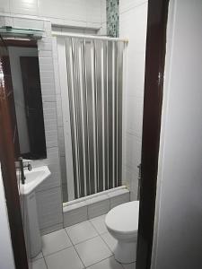 y baño con aseo y ducha. en Oásis Tropical: Flat de Luxo na Beira, Moçambique, en Beira