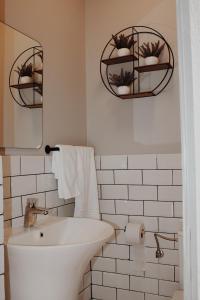 a bathroom with a tub and a sink and a mirror at Popasul Graniceresc in Năsăud