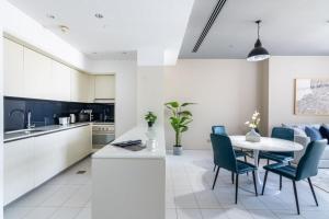 a kitchen and dining room with a table and chairs at Silkhaus contemporary 1BDR with Downtown view in DIFC in Dubai