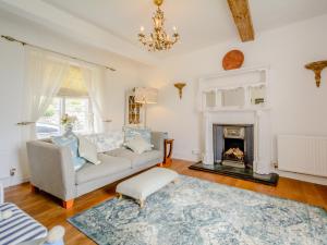 a living room with a couch and a fireplace at 3 Bed in Nailsworth 78968 in Nailsworth