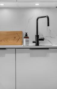 a kitchen counter with a sink and a faucet at The Nordic Hideaway in Tromsø