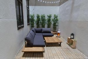 um pátio com um sofá, uma mesa e plantas em Justus I levestate em Viena