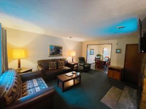 a living room with a couch and a table at Pool-Pinecrest Townhomes-1King-2Queen Unit in Pigeon Forge