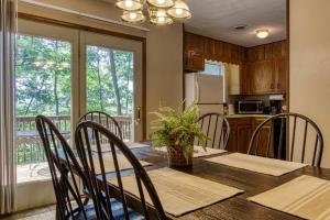 a dining room with a table and chairs and a kitchen at Pool-Pinecrest Townhomes-1King-2Queen Unit in Pigeon Forge