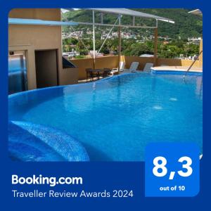 a large blue swimming pool on top of a building at Fabuloso Hotel Las Vegas in Zihuatanejo