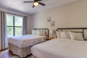 a bedroom with two beds and a ceiling fan at Pool-Pinecrest Townhomes-1King2Queen- RENOVATED in Pigeon Forge