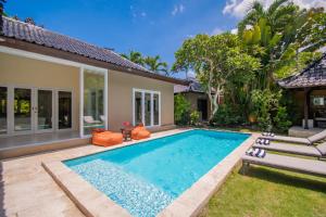 a swimming pool in the backyard of a villa at Sitara Villa in Seminyak