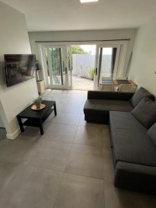 a living room with a couch and a table at Cozzy Apartment on the Caribbean side-Frigate Bay in Frigate Bay