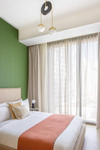 a bedroom with a large bed and a large window at Silkhaus with marina & beach view 1BDR near Bluewaters Island in Dubai
