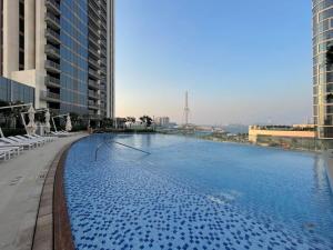 a large swimming pool on top of a building at Silkhaus with marina & beach view 1BDR near Bluewaters Island in Dubai