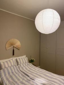 a bedroom with a bed with a lamp and a largeumedumedumedumedumed at Cozy appartment for 2 in Aarhus in Aarhus