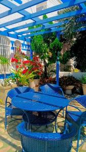 a blue table and chairs with plants on a patio at Pousada Areia da Praia in Fortaleza