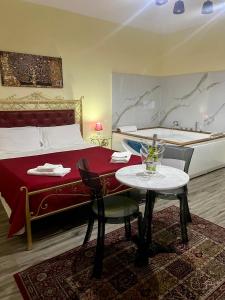 a hotel room with a bed and a table with a table sidx sidx at Duca di Uzeda Bed & Breakfast Luxury and Style in Catania