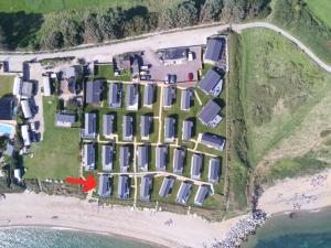 an aerial view of a house on a beach at Pemberton Avon pitch 30 Creek Caravan Park dog friendly in Ringstead