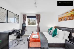 a bedroom with a bed and a desk and a chair at Caraway Heights 2Bedroom Apt Sleeps 6 in Canary Wharf, London with Free Parking, Wifi & Leisure By Maison Christo Property Short Lets & Serviced Accommodation in London