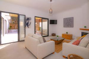 a living room with two white couches and a tv at 269 Son Moro ETV7750 by Mallorca Charme in Muro