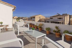 a patio with chairs and a table on a balcony at 269 Son Moro ETV7750 by Mallorca Charme in Muro