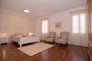 a living room with a bed and two chairs at 269 Son Moro ETV7750 by Mallorca Charme in Muro +40 photos