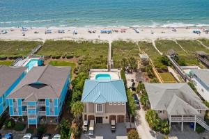 an aerial view of a house and the beach at Blue Heaven amazing custom home with private heated pool close to beach in Ocean Isle Beach