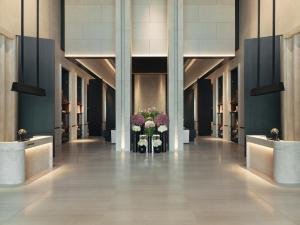 a hallway with two vases with flowers in it at La Réserve Resort in Knokke-Heist