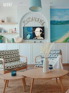 a living room with two chairs and a coffee table at CĂN HỘ CAO CẤP FLC SEATOWN QUY NHƠN in Quy Nhon