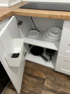 a kitchen with white cabinets and a counter top at EA flat in Sfântu-Gheorghe