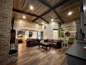 a living room with two couches and a table at Elegant Country Cottage in Caldwell Crossing