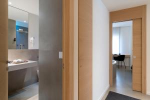 a bathroom with a door leading into a room at Catania Smart Apartments in Catania