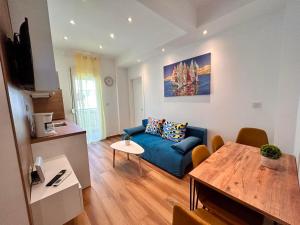a living room with a blue couch and a table at Relax Apartment II in Perea