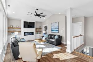 a living room with a couch and a chair at Coastal Charm Ocean Isle Beach custom beach home with 4 bedroom, 3 bath home with pool and elevator in Ocean Isle Beach