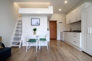 a kitchen and a dining room with a table and chairs at Modern 1BR / Near Gates of Dawn / Special Offer in Vilnius