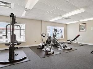 a gym with treadmills and exercise bikes in a room at Two Bedroom Condo With Views Of The Beach & Gulf in St Pete Beach