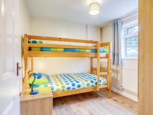 a bedroom with bunk beds with a desk and a window at 2 bed property in Coleford 77702 in Staunton