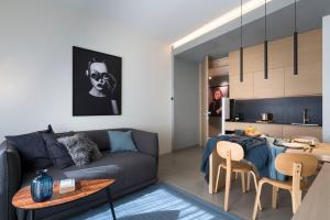 a living room with a couch and a table at Catania Smart Apartments in Catania
