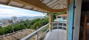 a balcony of a house with a view of the city at Residencial Santa Maria in Laguna