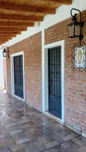 two doors on the side of a brick building at DIVINA CASITA PASO DE LA PATRIA in Paso de la Patria